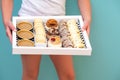 Girl Delivering The Diverse Sweets In A Tray To The Table. Royalty Free Stock Photo