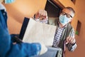 Girl is delivering some groceries to an elderly person.Contactless delivery during the quarantine Royalty Free Stock Photo