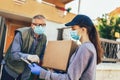 Girl is delivering some groceries to an elderly person, during the epidemic coronovirus, COVID-19 Royalty Free Stock Photo