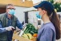 Girl is delivering some groceries to an elderly person, during the epidemic coronovirus, COVID-19