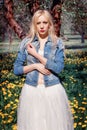 Girl in a denim jacket enjoys the flowers early in the morning Royalty Free Stock Photo