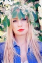 Girl in a denim jacket enjoys the flowers early in the morning Royalty Free Stock Photo