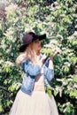 Girl in a denim jacket enjoys the flowers early in the morning Royalty Free Stock Photo