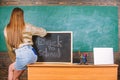 Girl denim skirt breaking school clothing rules. Student teacher mini skirt sexy buttocks sit table blackboard