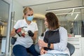 girl dentist shows a model of jaws as a visual aid to a girl patient.