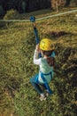 Girl descending by cable in a zip-line