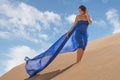 Girl in Desert with Blue Flowing Silk