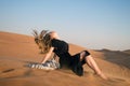 The girl develops hair from the wind in the desert. Royalty Free Stock Photo