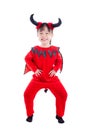 Girl in devil halloween costume standing over white