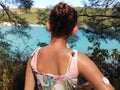 Girl with diabetes looks at the bay, beautiful turquoise sea and beach. On right arm is placed white sensor for continuous glucose Royalty Free Stock Photo