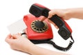 The girl dials number on red phone