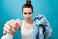 Girl directs a spray bottle of cleaning agent into camera and holds out a rag