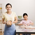 Girl displays baked loaf of bread