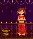 Girl with diya celebrating Diwali festival of India