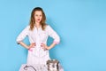 Girl doctor in medical gown with syringe. blue background. copy space