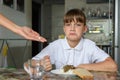 The girl does not like the medicines offered by her mother before dinner Royalty Free Stock Photo