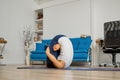 Girl does yoga at home bending knees to her chest