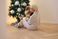 girl with a dog on the background of a christmas tree