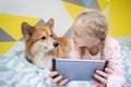 Girl and dog on the bed in the nursery