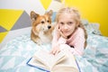 Girl and dog on the bed in the nursery