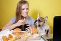 Girl and dog eating fast food