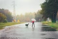 The girl with a dog goes through the puddles