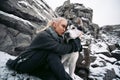 Girl with dog Malamute among rocks in winter. Close up. Royalty Free Stock Photo