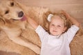 Girl, dog and relax in portrait for bonding, care and pet for support on floor of living room in home. Child, golden Royalty Free Stock Photo