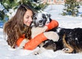 Girl with a dog in the snow.