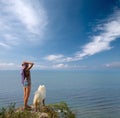 Girl and dog standing on precipice