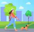 A girl with a dog is walking on the street. Female character spends time outdoors with her pet