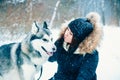 Girl and a dog in the winter forest