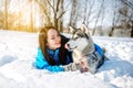 Girl with a dog in winter Husky