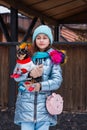 Girl and dog in winter. Teenager girl in blue jacket. Girl and chihuahua in clothes