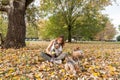 Beautiful young girl with her Yorkshire terrier dog puppy enjoying and playing in the autumn day in the park selective focus Royalty Free Stock Photo