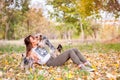 Beautiful young girl with her Yorkshire terrier dog puppy enjoying and playing in the autumn day in the park selective focus