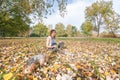 Beautiful young girl with her Yorkshire terrier dog puppy enjoying and playing in the autumn day in the park selective focus