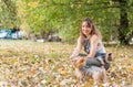 Girl with dogs, Beautiful young girl with her Yorkshire terrier dog puppy enjoying and playing in the autumn day in the park Royalty Free Stock Photo