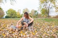 Girl with dogs, Beautiful young girl with her Yorkshire terrier dog puppy enjoying and playing in the autumn day in the park Royalty Free Stock Photo