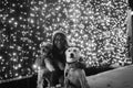 Girl with dogs and christmas lights