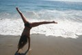 Girl Doing Cartwheel on the Beach Royalty Free Stock Photo