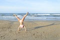 Girl doing cartwheel on the beach Royalty Free Stock Photo