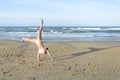 Girl doing cartwheel on the beach Royalty Free Stock Photo