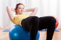 Girl doing crunches on gym ball Royalty Free Stock Photo