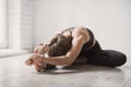 Girl doing exercises, practicing yoga in class, young woman meditating at home. Training, harmony, workout, meditation concept Royalty Free Stock Photo