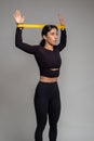 Girl doing exercises with resistance band loop in studio Royalty Free Stock Photo