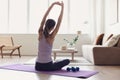 Girl doing fitness exercise, practicing yoga, young woman meditating at home. Royalty Free Stock Photo