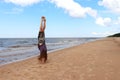 Girl doing handstand at the Baltic Sea in Latvia Royalty Free Stock Photo