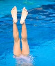 Girl doing a handstand in pool