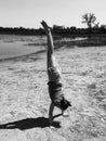 Girl Doing Handstand on a Beach in Black and White Royalty Free Stock Photo